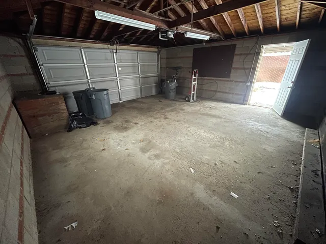 a backyard of a house with basket ball court and wooden floor