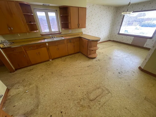 a bathroom with a tub sink and mirror