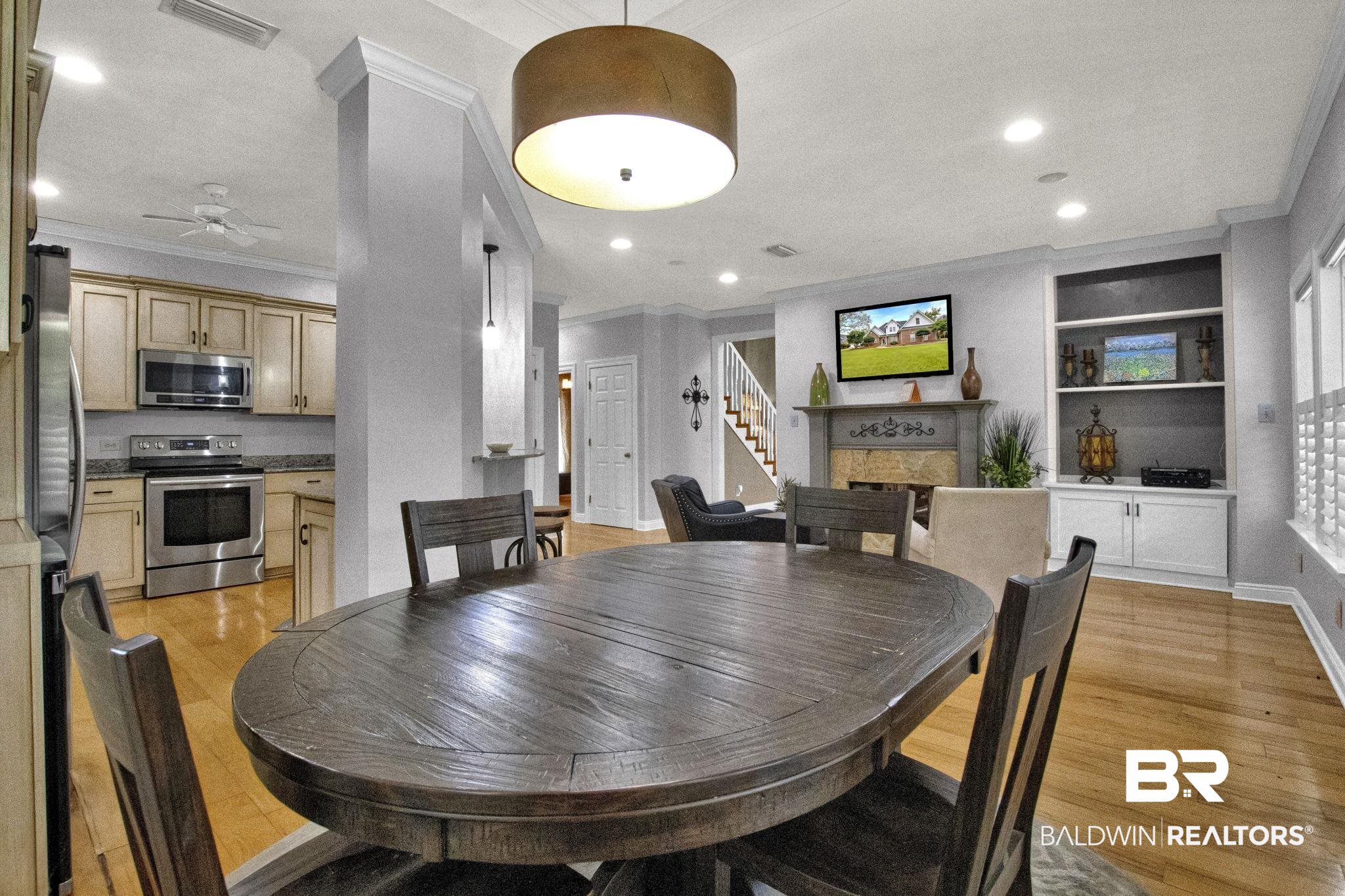 9002 Parliament Circle Daphne, AL 36526 - Photo 22 of 73 Dining space featuring built in features, crown molding, ceiling fan, and light hardwood / wood-style floors