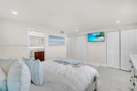 a bedroom with a bed and a view of kitchen