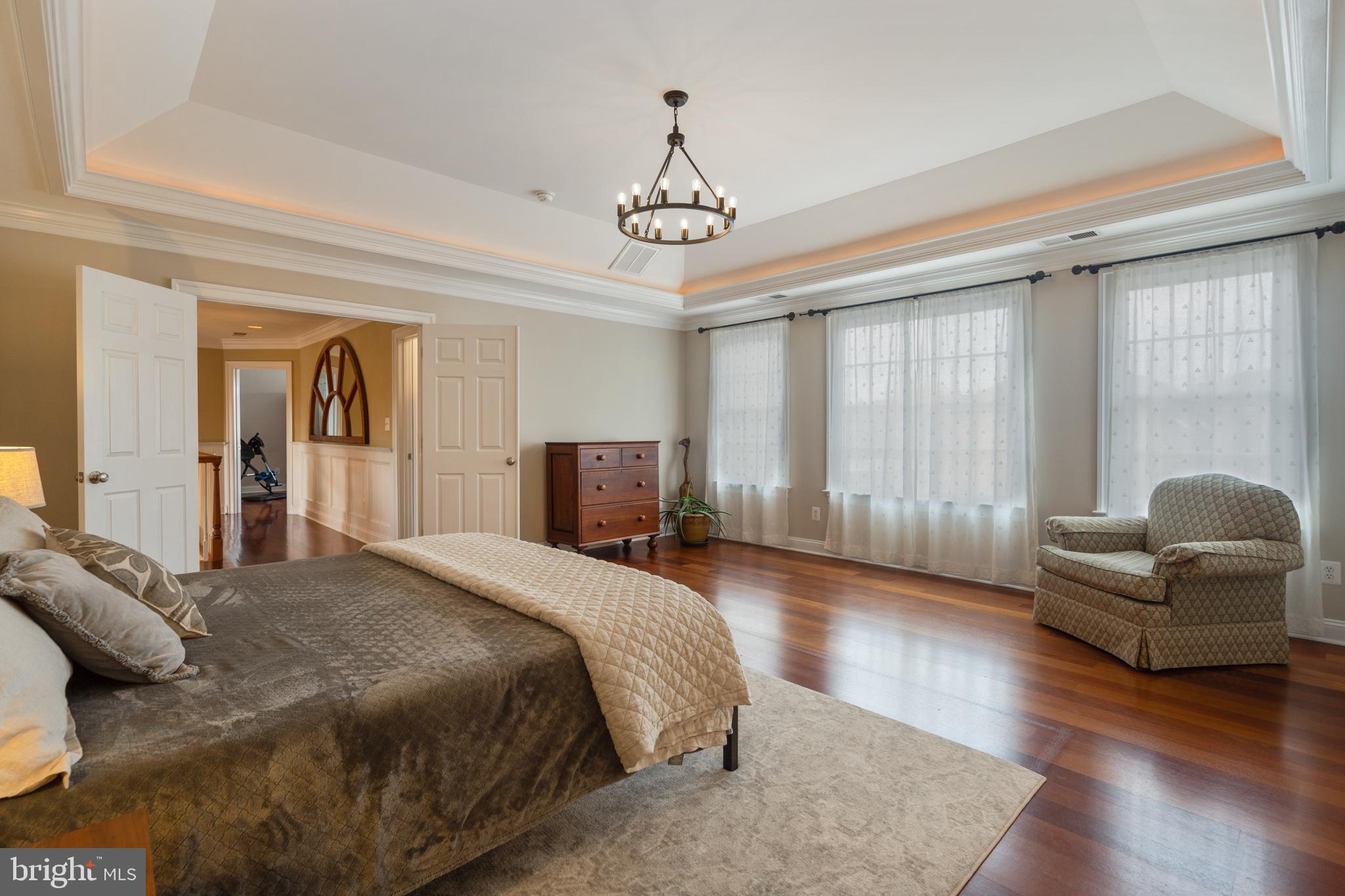8291 Roxborough Loop Gainesville, VA 20155 - Photo 27 of 39 Master bedroom with rope lighting and hardwoods