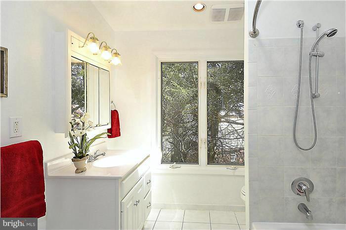 9903 Sidney Road Silver Spring, MD 20901 - Photo 14 of 26 a bathroom with a granite countertop sink a mirror and a shower