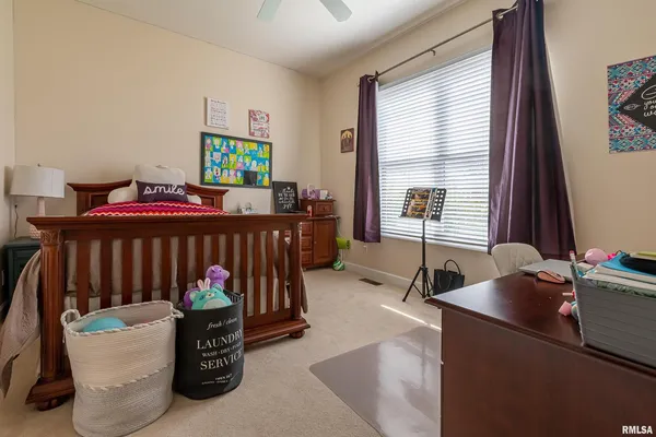 a bedroom with furniture and a window
