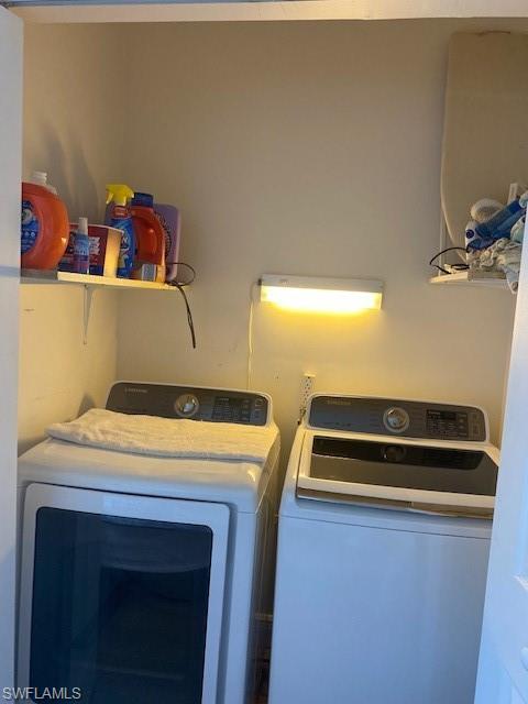 907 Manatee Road Naples, FL 34114 - Photo 17 of 26 a view of storage and utility room with washer and dryer