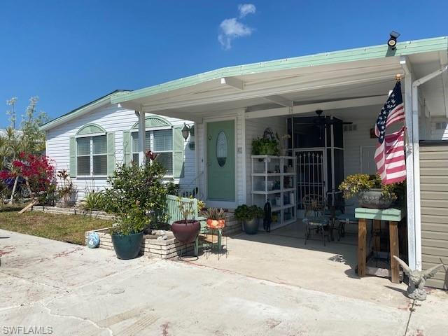 907 Manatee Road Naples, FL 34114 - Photo 3 of 26 a view of a house with potted plants in front of house