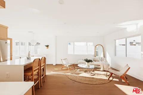 a dining room with furniture and wooden floor