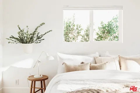 a bedroom with a bed and a window