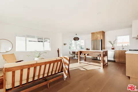 a bedroom with furniture and a large window