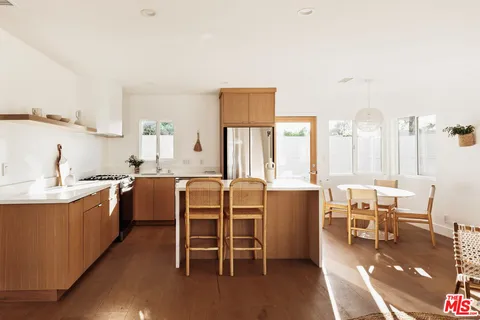 a large kitchen with a table and chairs in it