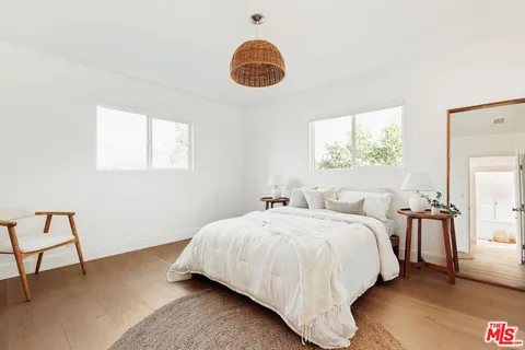 a bedroom with bed and a window