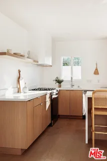 a kitchen with a sink cabinets and window