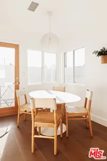 a view of a dining room with furniture wooden floor and a chandelier