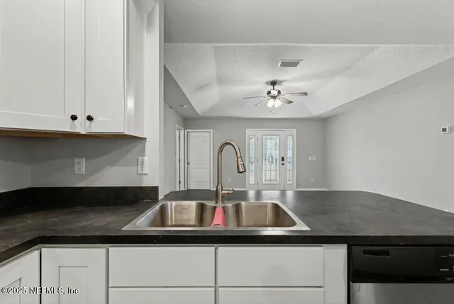 a kitchen with a sink and cabinets