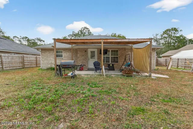 a view of a house with backyard porch and sitting area