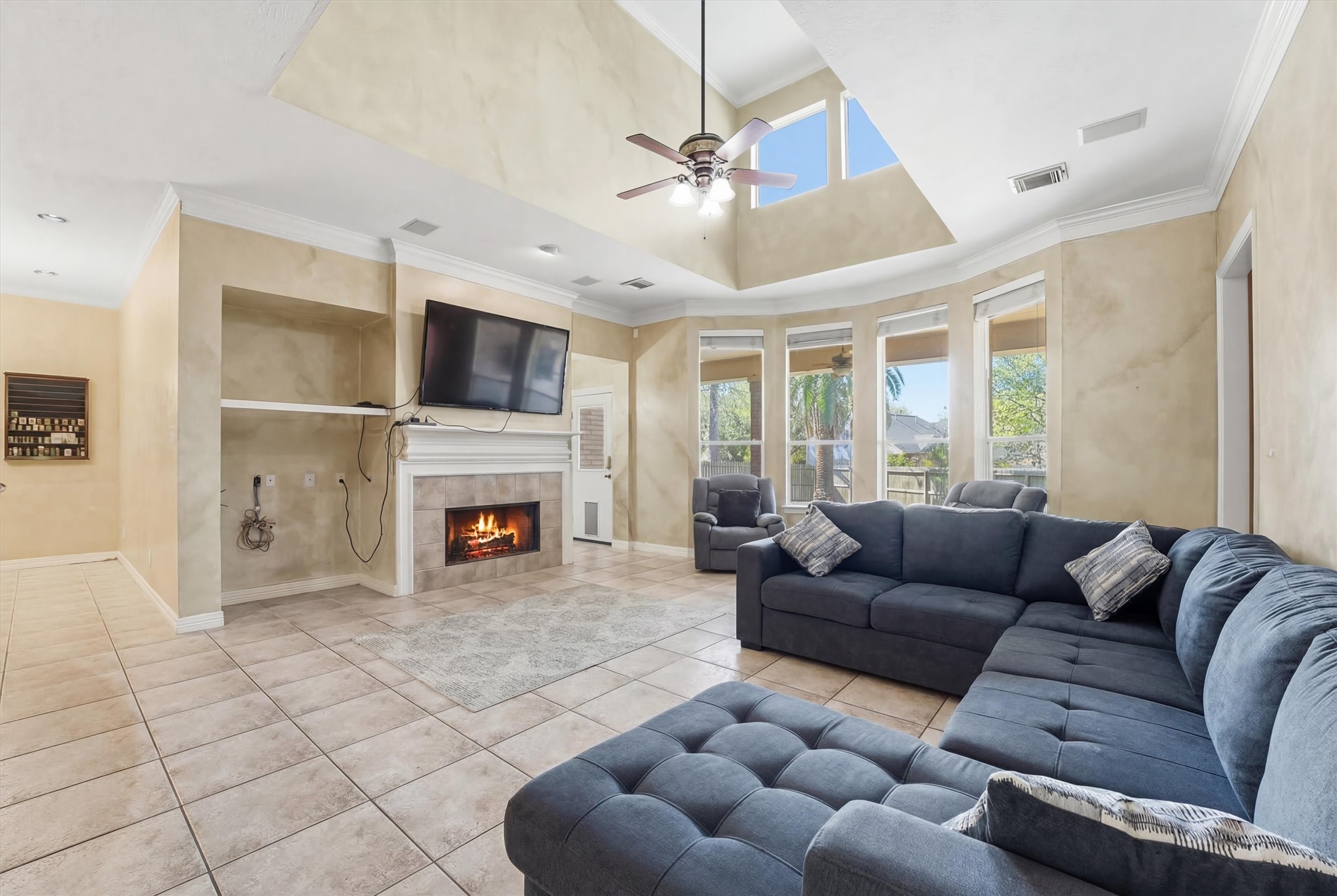 7303 Texas Laurel Loop Humble, TX 77346 - Photo 14 of 32 a living room with furniture a fireplace and a flat screen tv