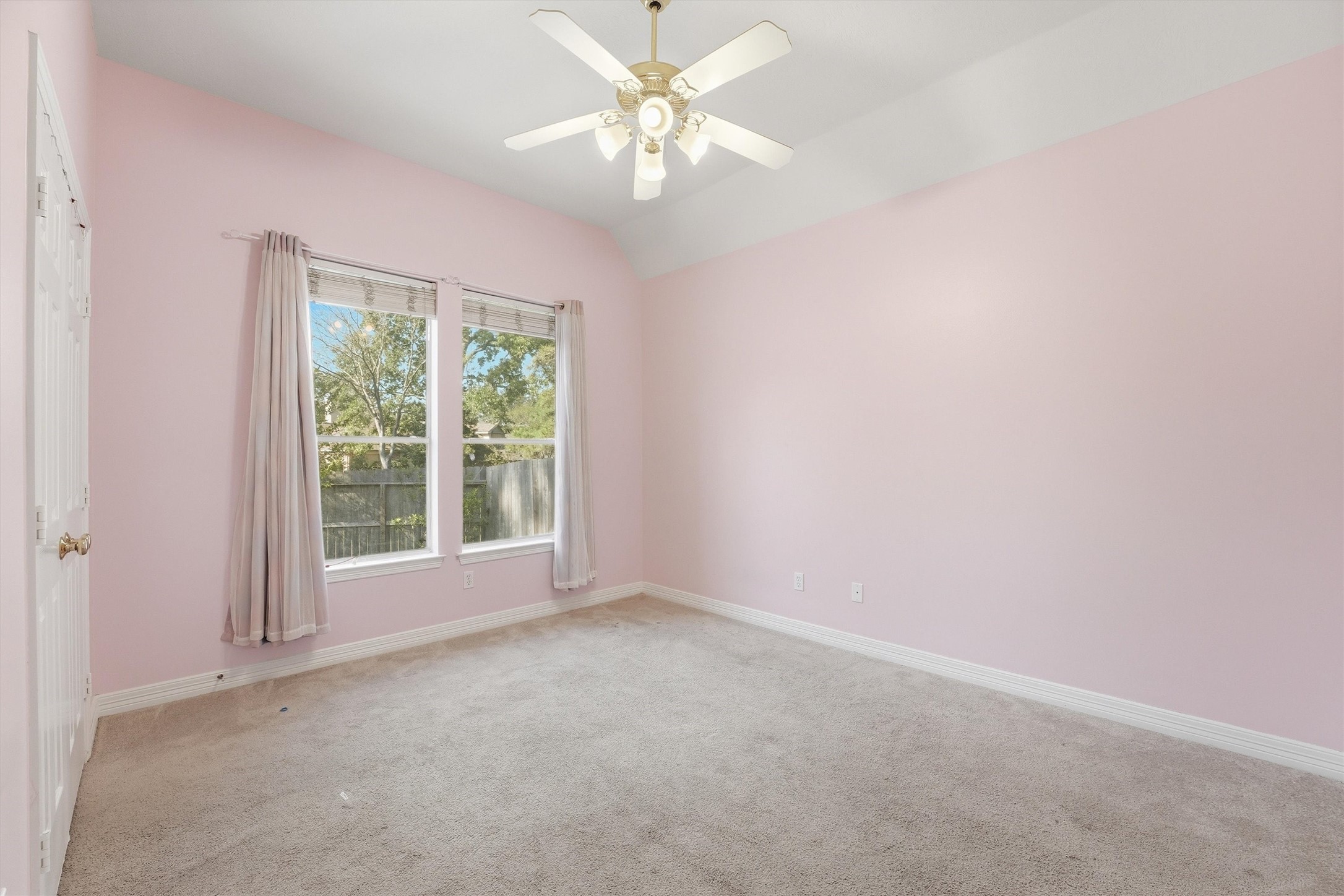 7303 Texas Laurel Loop Humble, TX 77346 - Photo 17 of 32 an empty room with a window and a fan