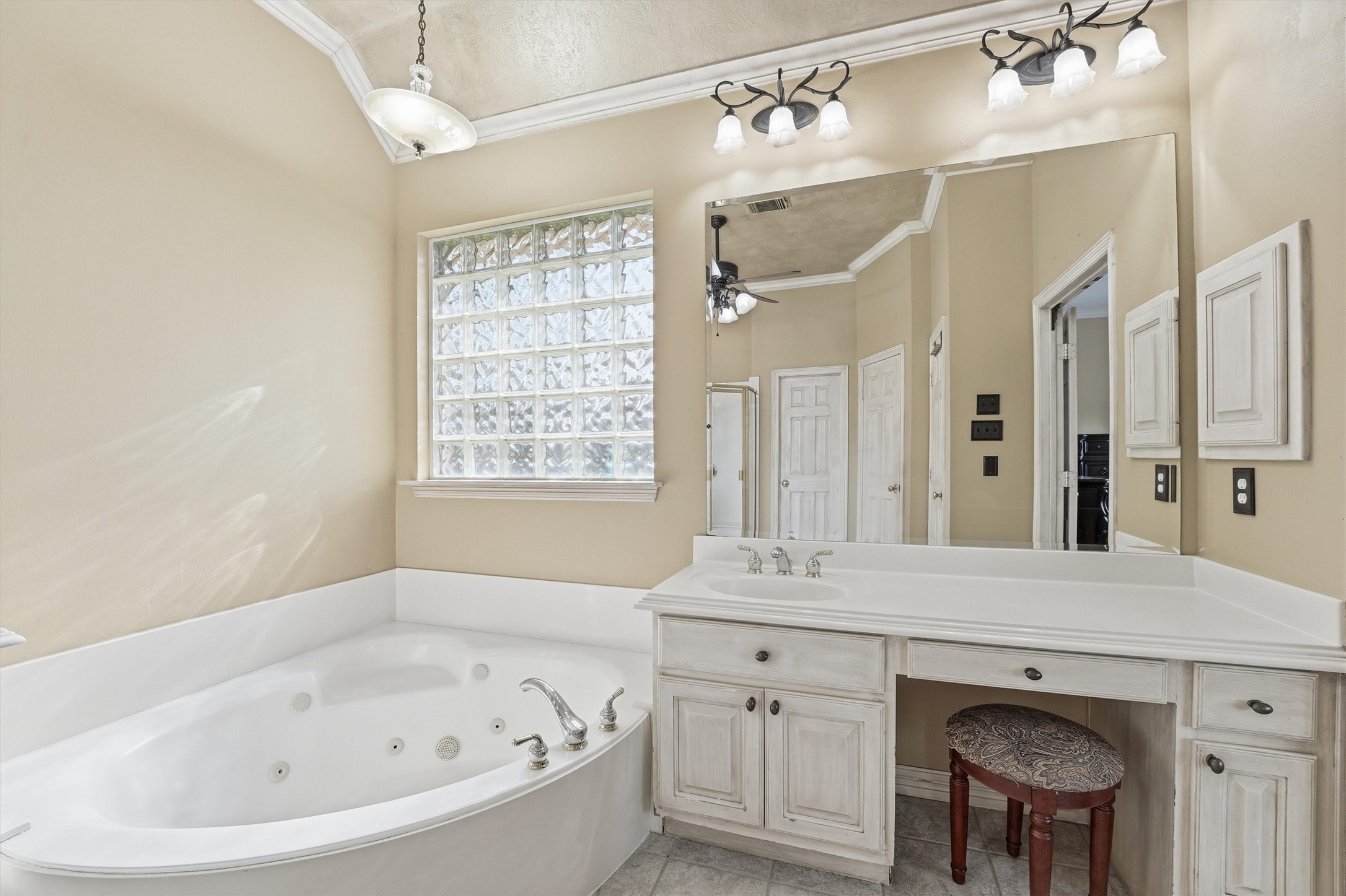7303 Texas Laurel Loop Humble, TX 77346 - Photo 21 of 32 a bathroom with a bathtub a sink and a window