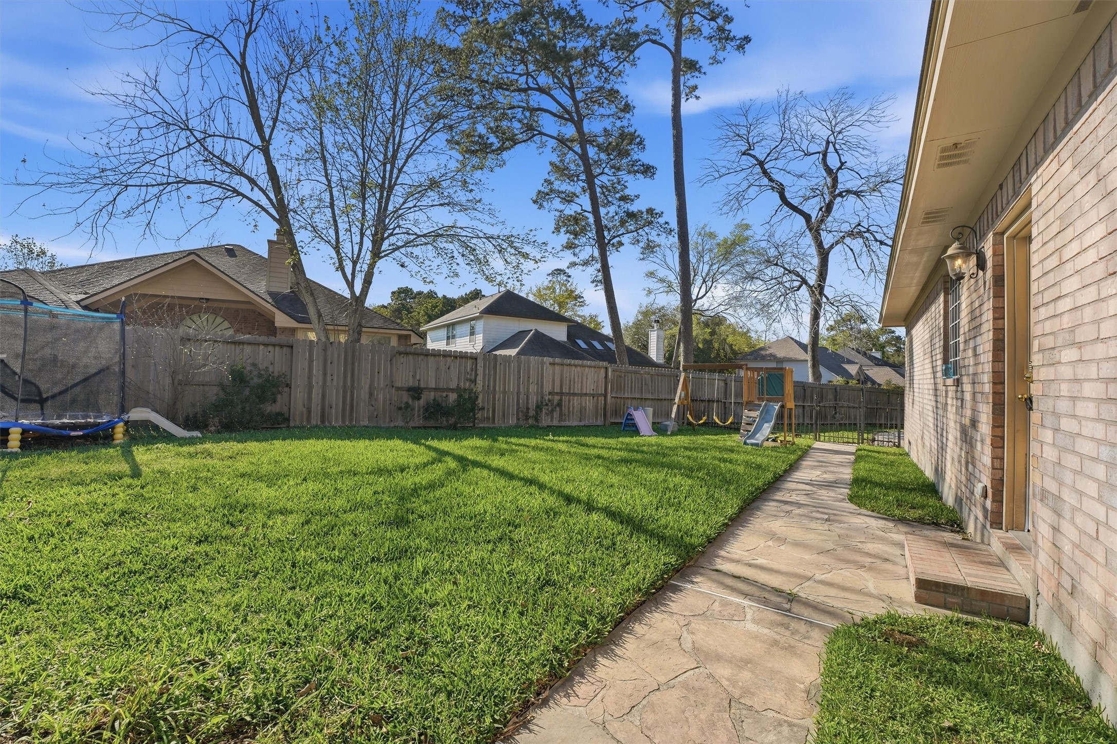 7303 Texas Laurel Loop Humble, TX 77346 - Photo 27 of 32 a backyard of a house with lots of green space