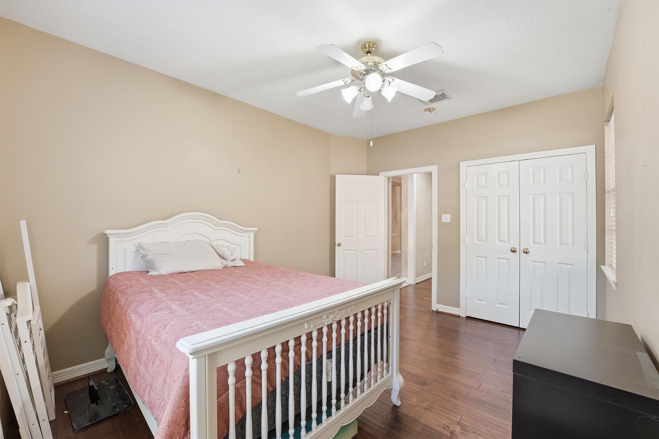 7303 Texas Laurel Loop Humble, TX 77346 - Photo 6 of 32 a bedroom with a bed and a chandelier