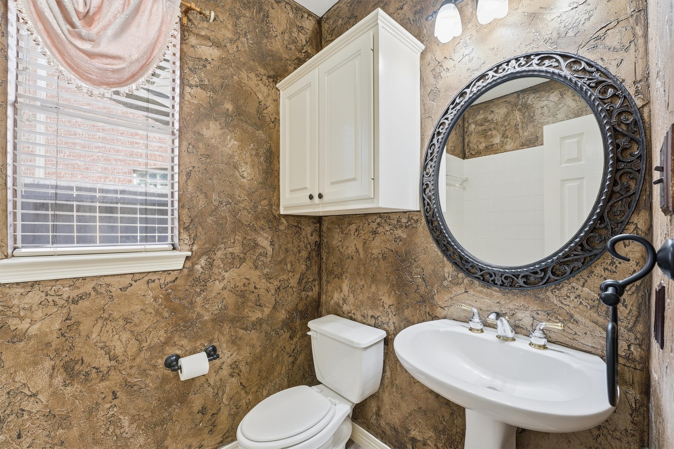 7303 Texas Laurel Loop Humble, TX 77346 - Photo 7 of 32 a bathroom with a toilet sink mirror and vanity
