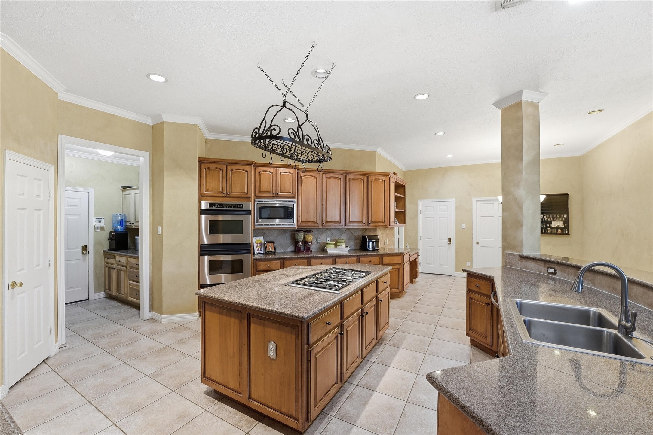 7303 Texas Laurel Loop Humble, TX 77346 - Photo 10 of 32 a kitchen with stainless steel appliances granite countertop a sink and a refrigerator