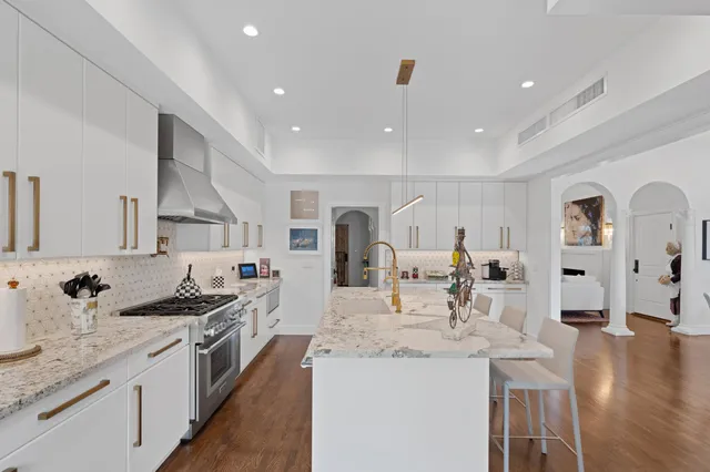 a kitchen with stainless steel appliances kitchen island granite countertop a sink and cabinets