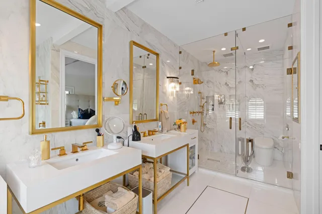 a bathroom with a double vanity sink mirror and shower