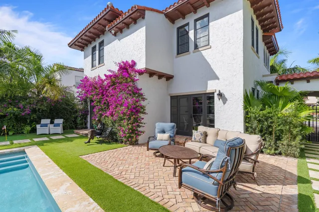 a view of a house with backyard porch and sitting area