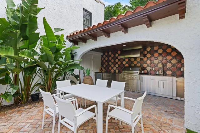 a view of patio with table and chairs and potted plants