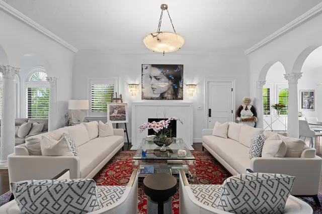 a living room with furniture a chandelier and a window