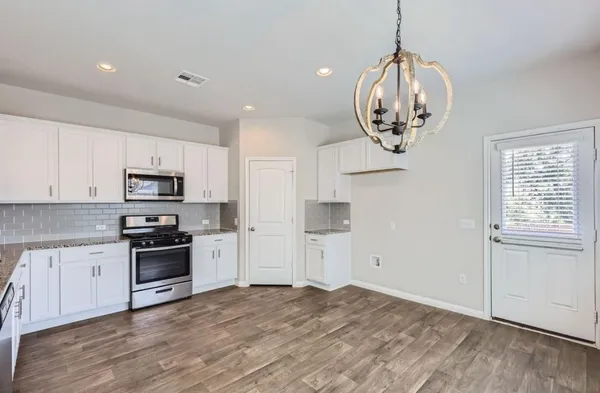a view of a kitchen with an empty space and a window