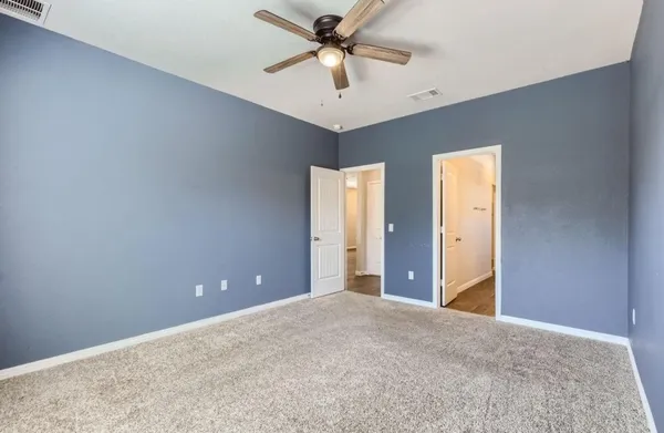 a view of a livingroom with a chandelier fan