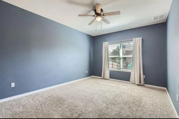 a view of a big room with windows