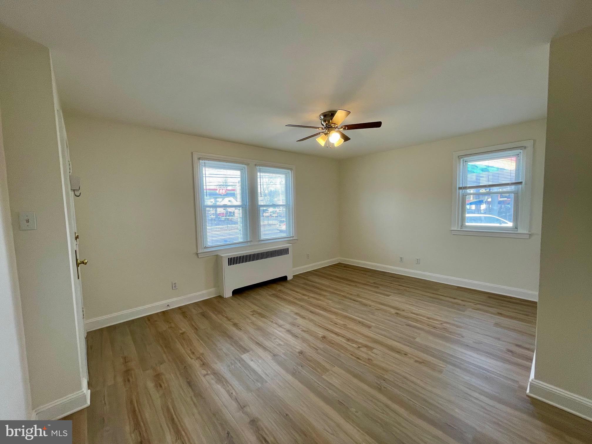 416 East Providence Road Aldan, PA 19018 - Photo 2 of 12 a view of an empty room with a window and wooden floor