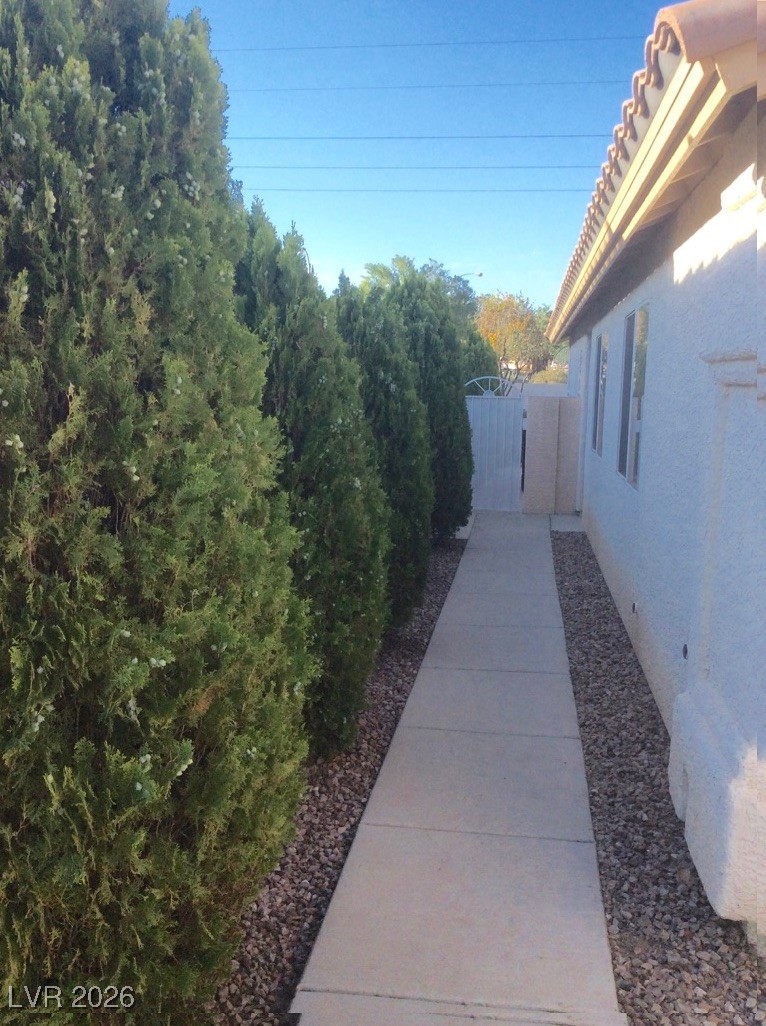 2115 Hidden Ranch Terrace Henderson, NV 89052 - Photo 2 of 30 View of side of home with a gate and stucco siding