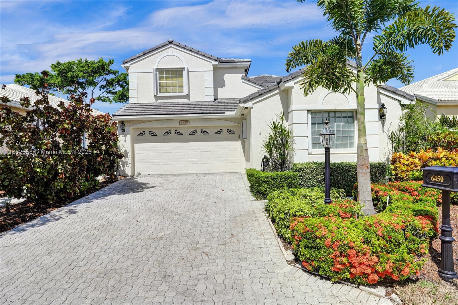 a front view of a house with a yard and outdoor seating