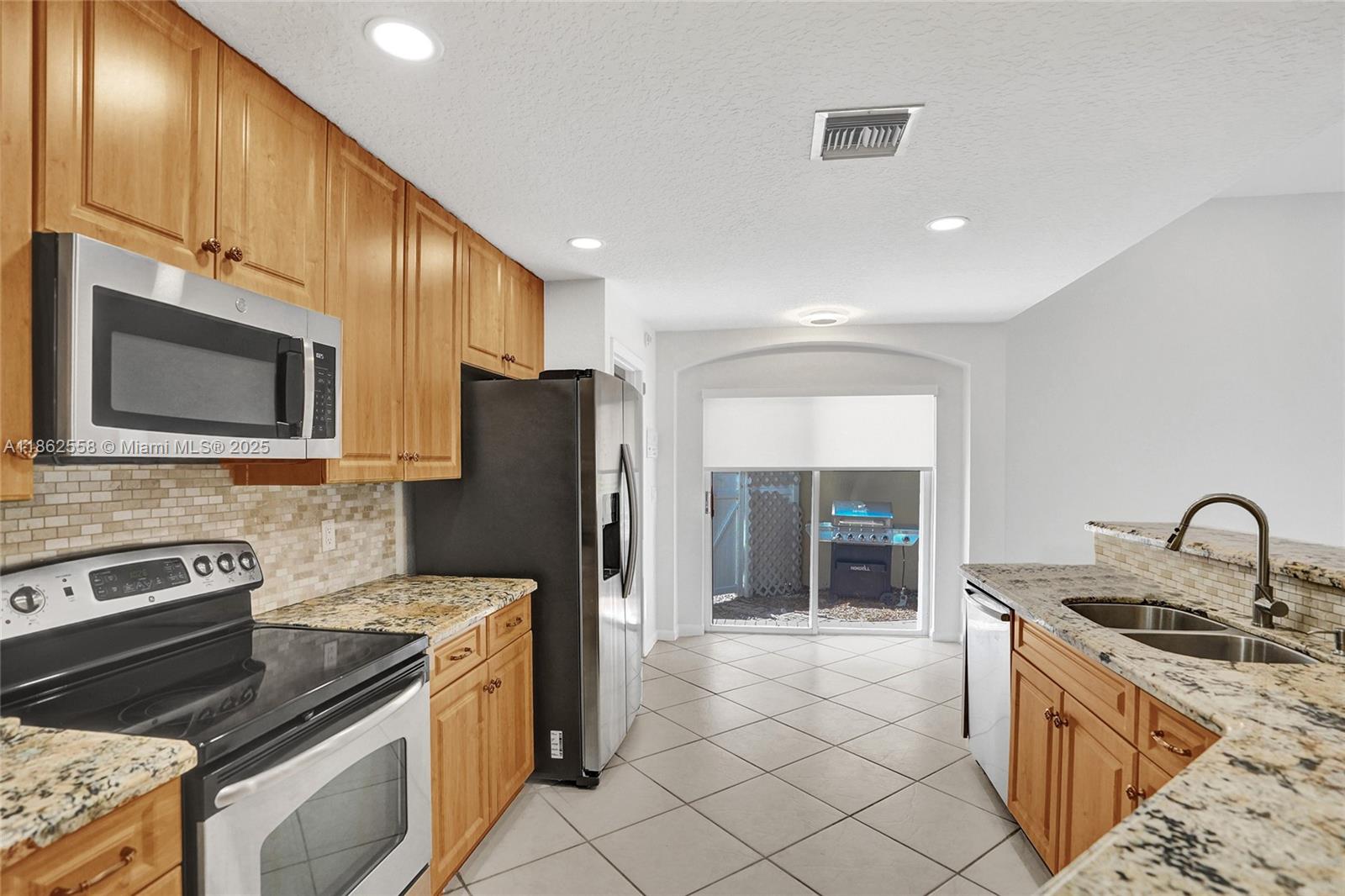 6450 Brava Way Boca Raton, FL 33433 - Photo 12 of 80 a kitchen with a sink stove and refrigerator