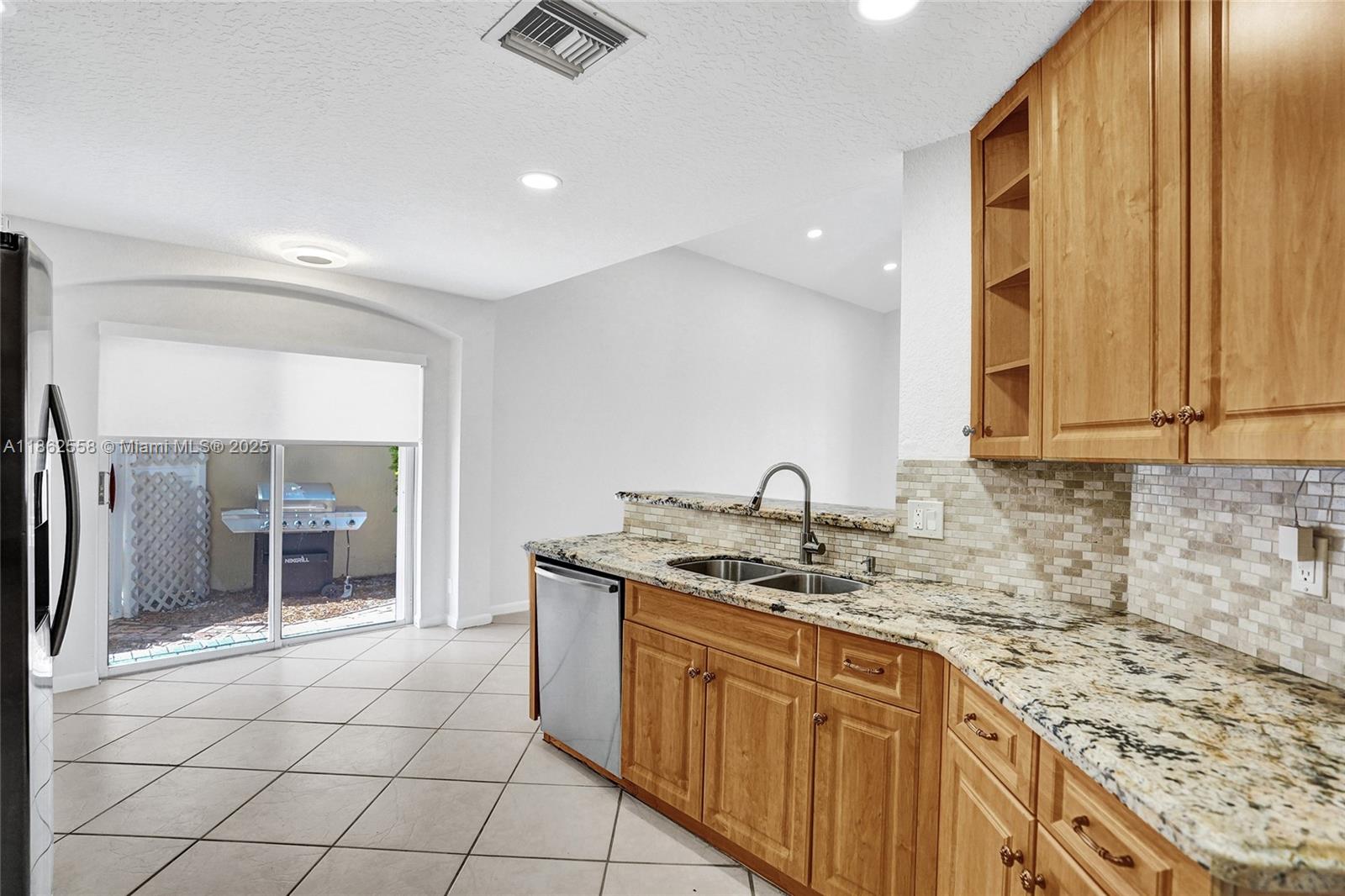 6450 Brava Way Boca Raton, FL 33433 - Photo 13 of 80 a kitchen with a sink stove and cabinets