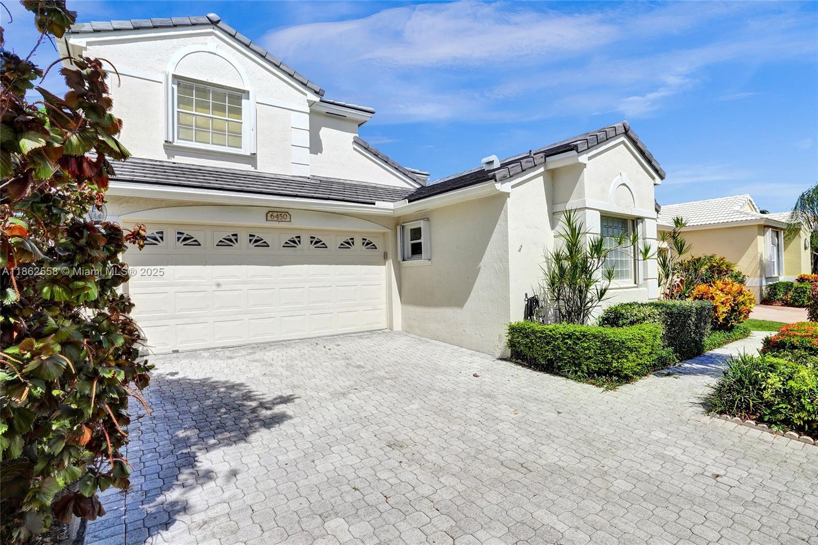 6450 Brava Way Boca Raton, FL 33433 - Photo 2 of 80 a front view of a house with garden