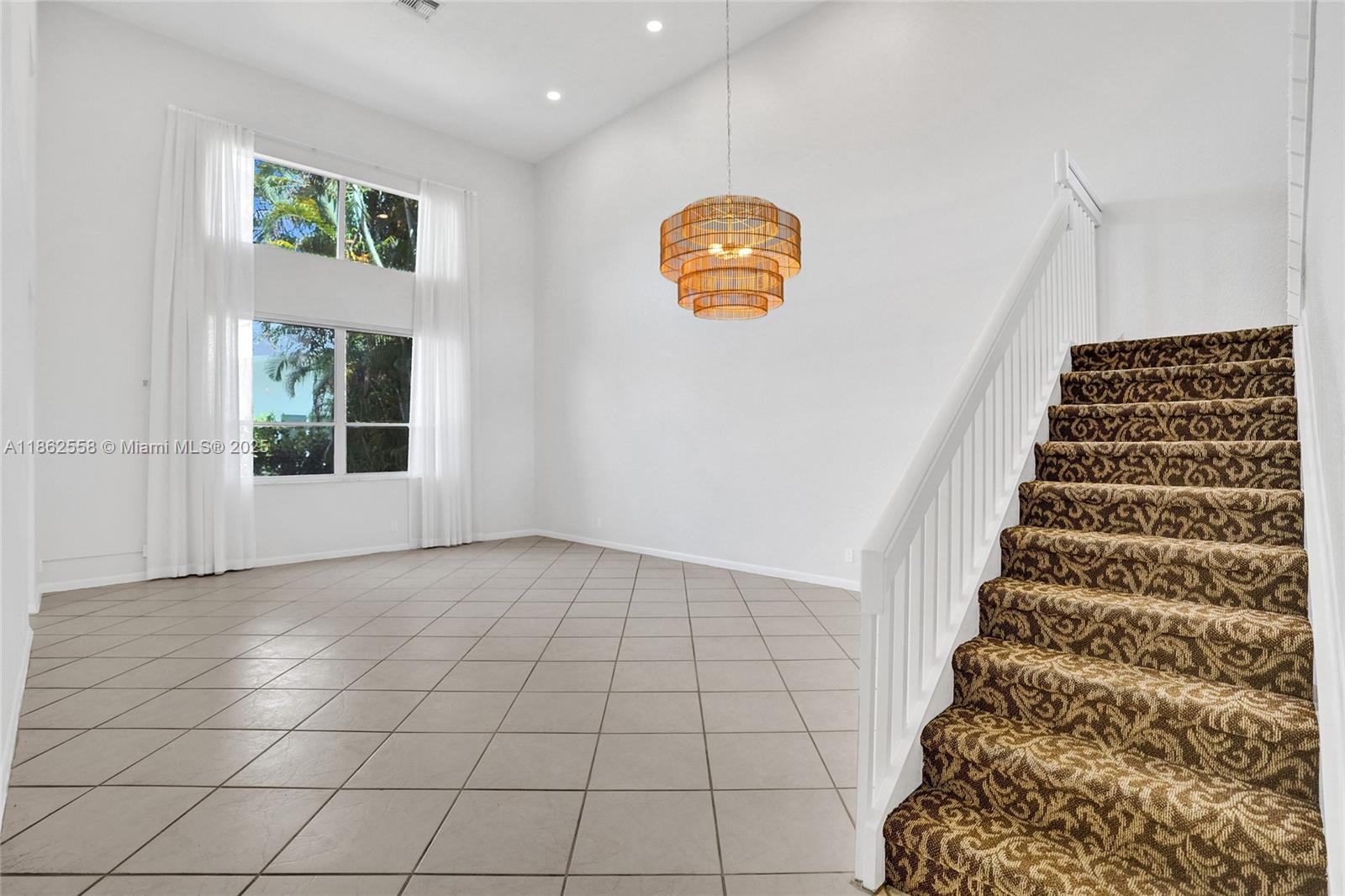 6450 Brava Way Boca Raton, FL 33433 - Photo 22 of 80 a view of an empty room and stairs