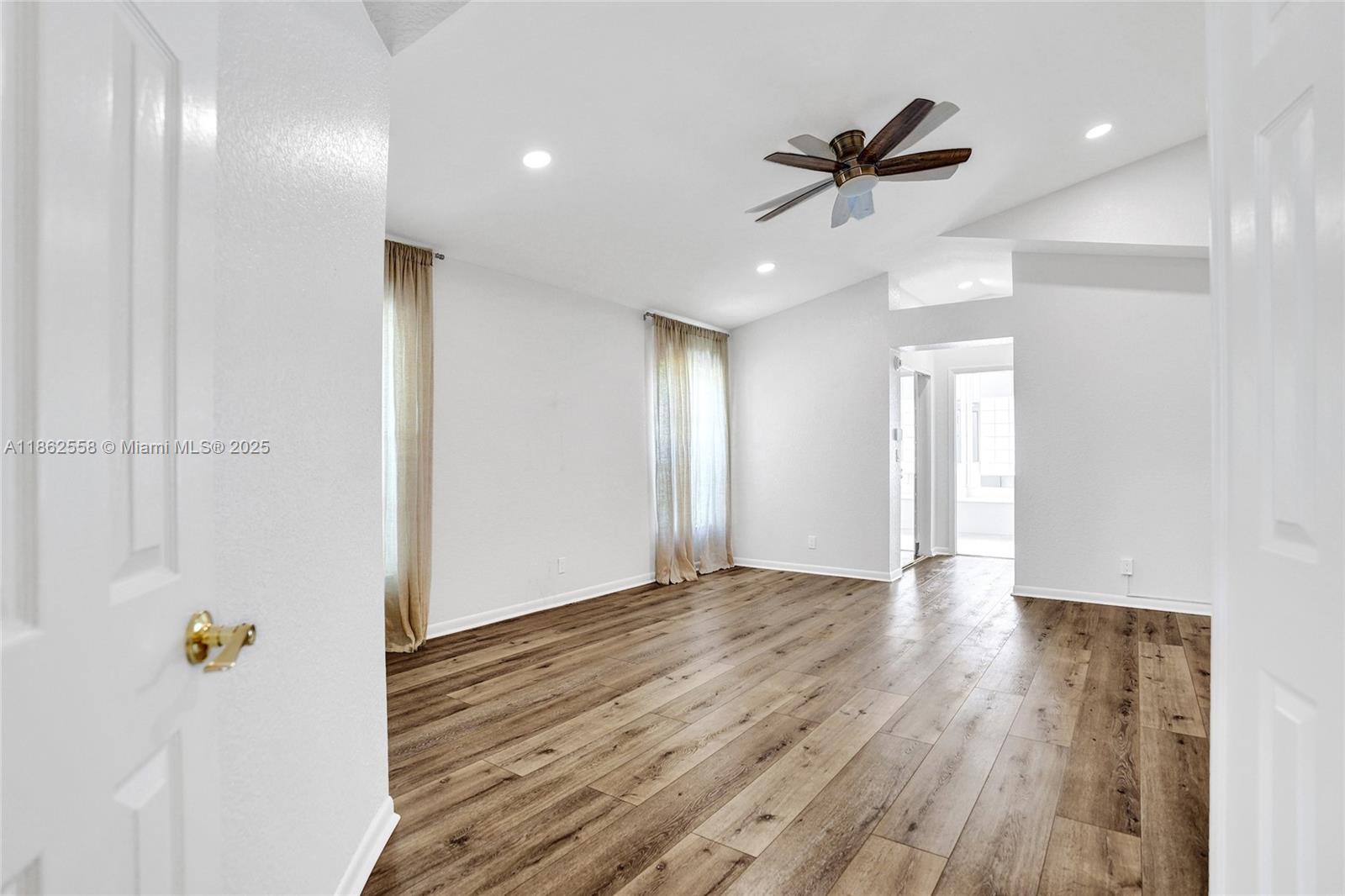 6450 Brava Way Boca Raton, FL 33433 - Photo 26 of 80 a view of an empty room with wooden floor and a ceiling fan