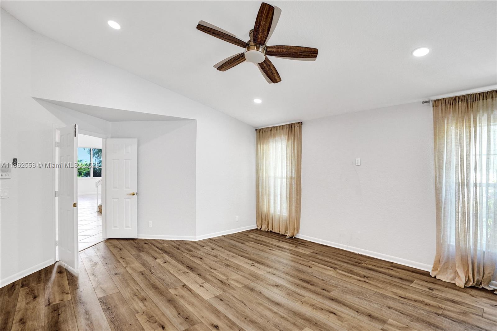 6450 Brava Way Boca Raton, FL 33433 - Photo 28 of 80 a view of empty room with wooden floor and ceiling fan