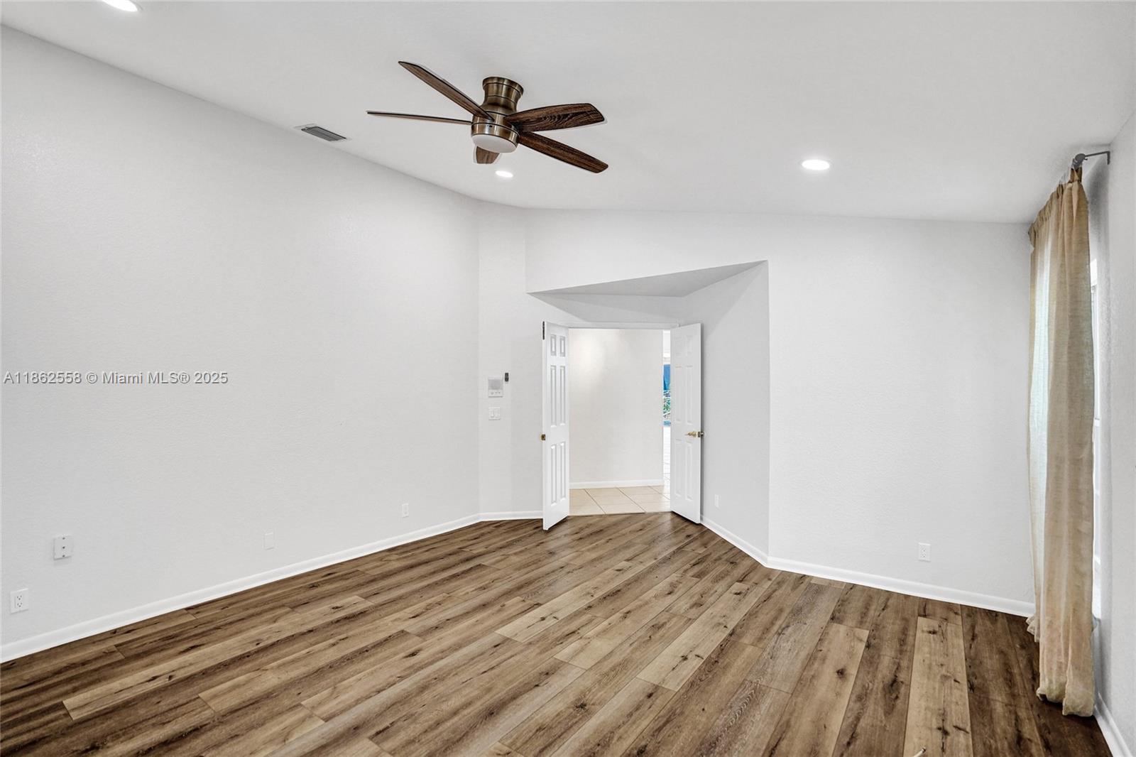 6450 Brava Way Boca Raton, FL 33433 - Photo 29 of 80 a view of a big room with wooden floor and windows
