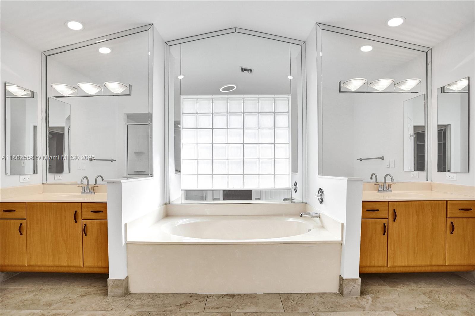 6450 Brava Way Boca Raton, FL 33433 - Photo 30 of 80 a spacious bathroom with a tub sink shower and mirror