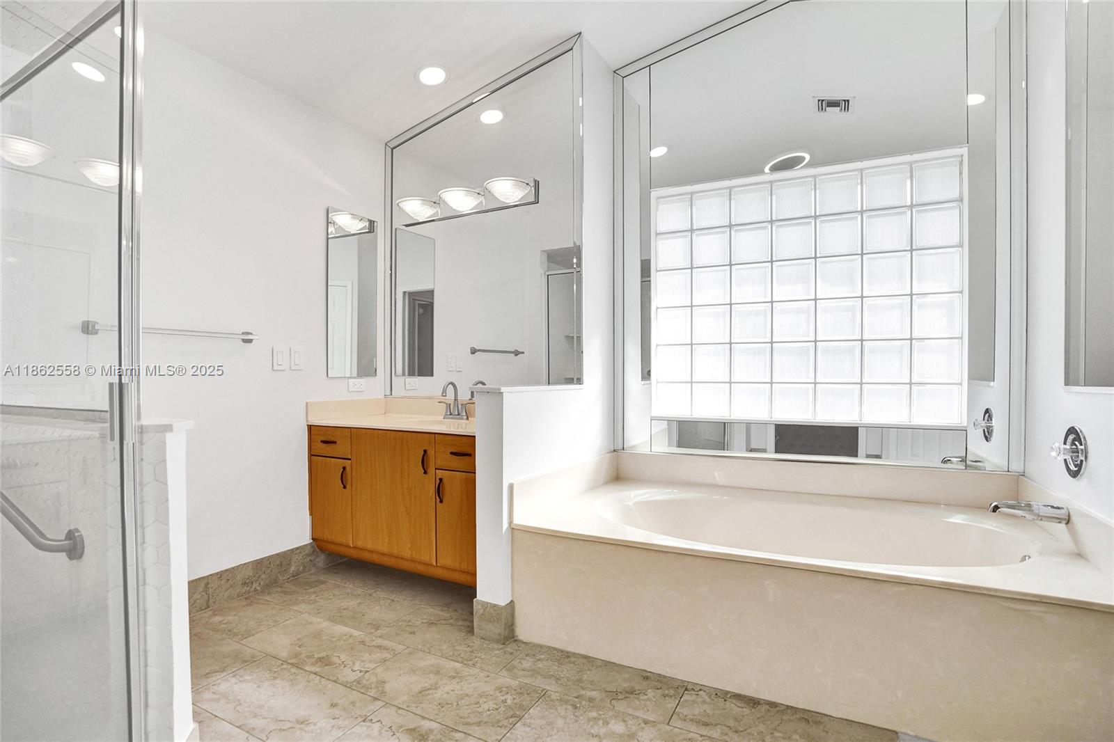 6450 Brava Way Boca Raton, FL 33433 - Photo 36 of 80 a spacious bathroom with a tub sink shower and mirror