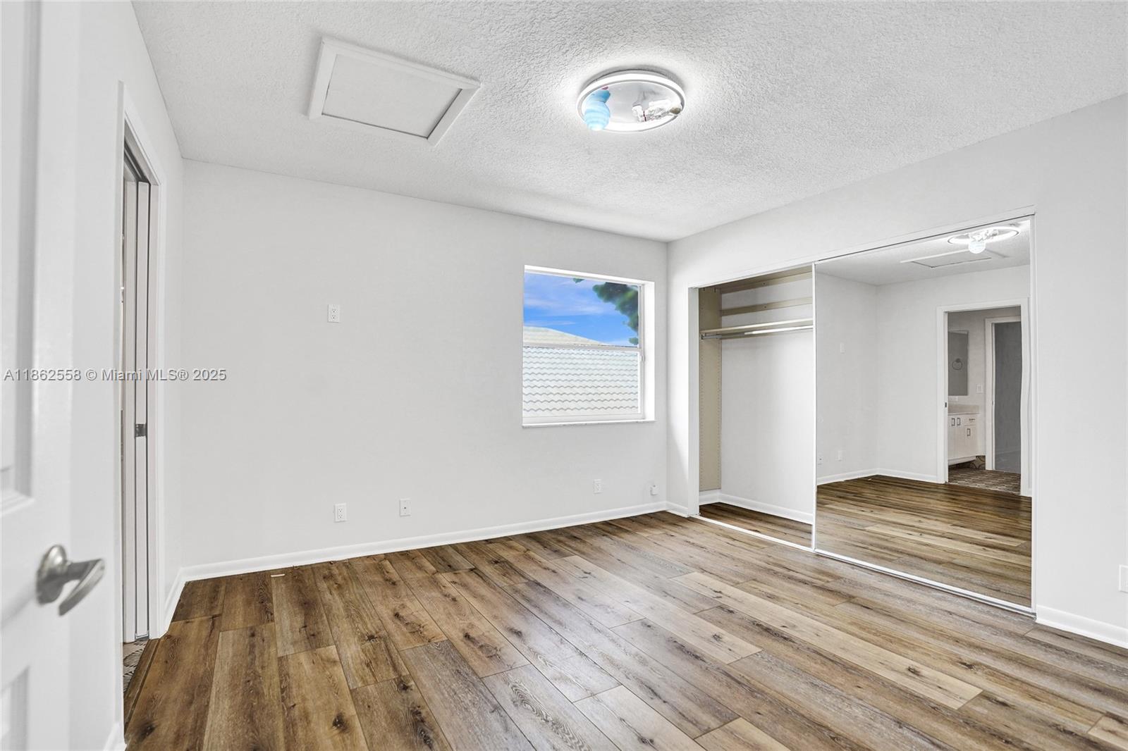 6450 Brava Way Boca Raton, FL 33433 - Photo 45 of 80 a view of an empty room with wooden floor
