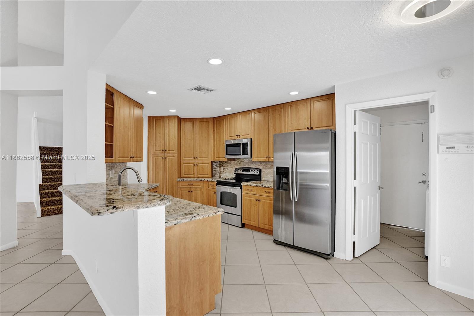 6450 Brava Way Boca Raton, FL 33433 - Photo 8 of 80 a kitchen with stainless steel appliances granite countertop a refrigerator oven a sink dishwasher and white cabinets with wooden floor