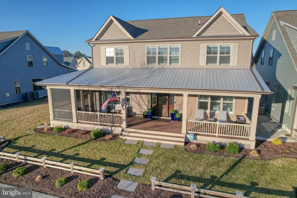 a aerial view of a house with a big yard and large trees