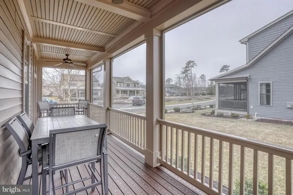a view of a livingroom with furniture and floor to ceiling window