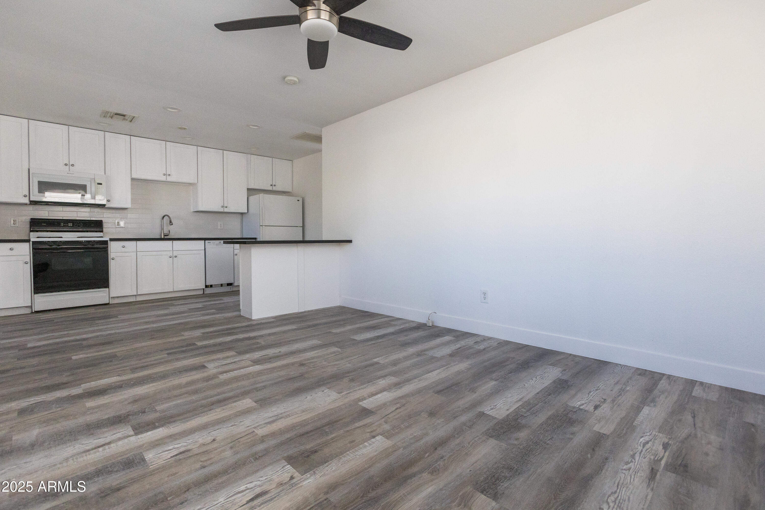 3417 East Windsor Avenue, Unit 2 Phoenix, AZ 85008 - Photo 5 of 12 a view of cabinets and wooden floor